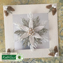 Decorative card with floral design and pinecones on a textured surface
