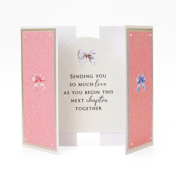 Greeting card with pink interior and decorative bows on a white background