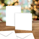 Two white cards on a wooden surface with blurred lights in the background