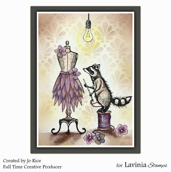Illustration of a raccoon on a spool of thread next to a mannequin with a purple dress, against a decorative background.