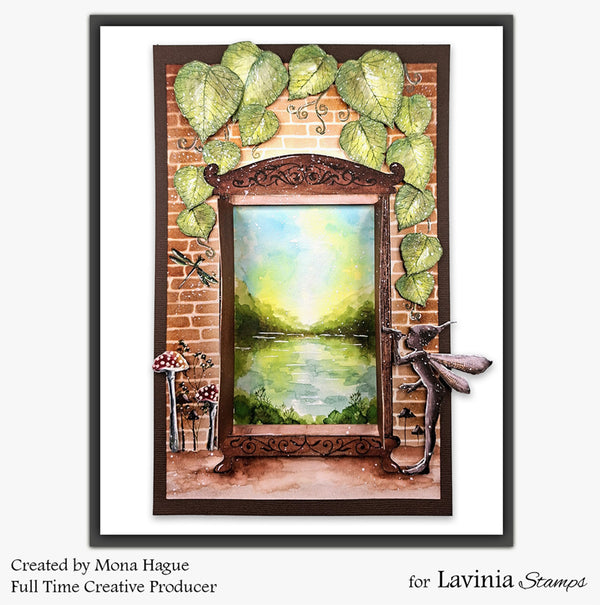 Framed artwork with a mirror, leaves, and a scenic view of a lake, created by Mona Hauge for Lavinia Stamps.