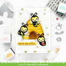 Card with bee-themed design and 'You're Bee-utiful!' text, surrounded by stamping tools on a white background.
