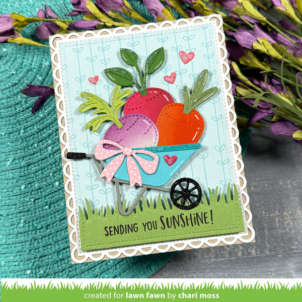 Colorful card with a wheelbarrow of carrots and flowers, featuring the text 'Sending you sunshine!'.