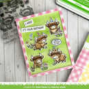Birthday card with cartoon bulls and stamp set on a wooden surface