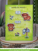 Green greeting card with cartoon cows and mailbox on a wooden surface