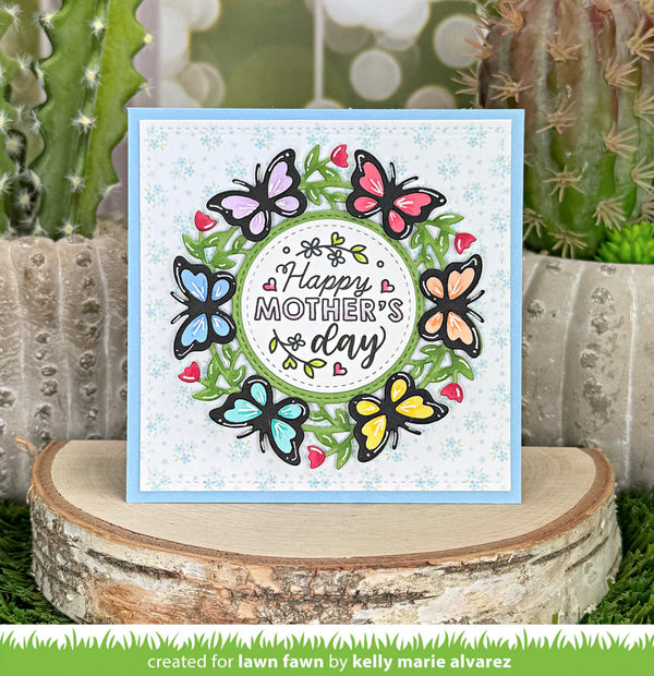 Mother's Day card with colorful butterflies on a wooden block with cacti in the background