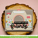 Card designed like a camera with floral patterns and text on a wooden slice background