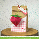 Decorative paper bag with strawberry design and text on a polka dot background