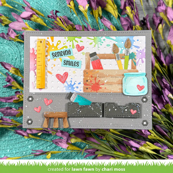 Colorful card with art supplies and flowers on a textured background