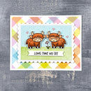 Card with two cartoon bulls and 'Long Time No See' text on a colorful geometric patterned background.