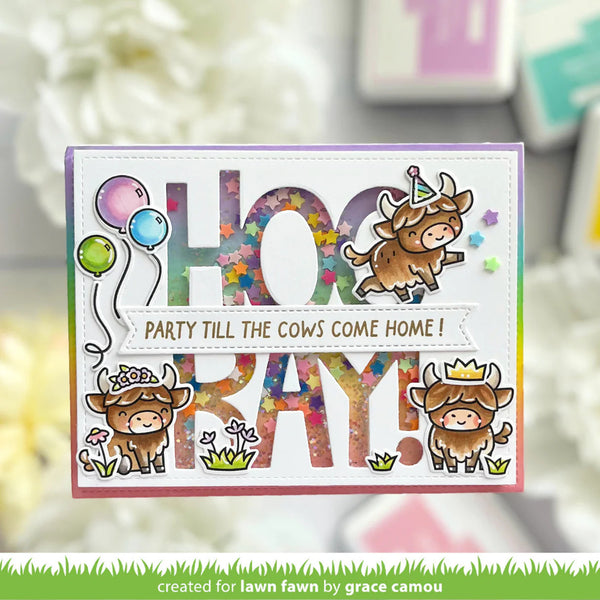 Birthday card with cartoon cows and colorful text on a blurred background