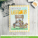 Card with lemon-themed design and text 'When life gives you lemons, make lemonade!' on a wooden surface.