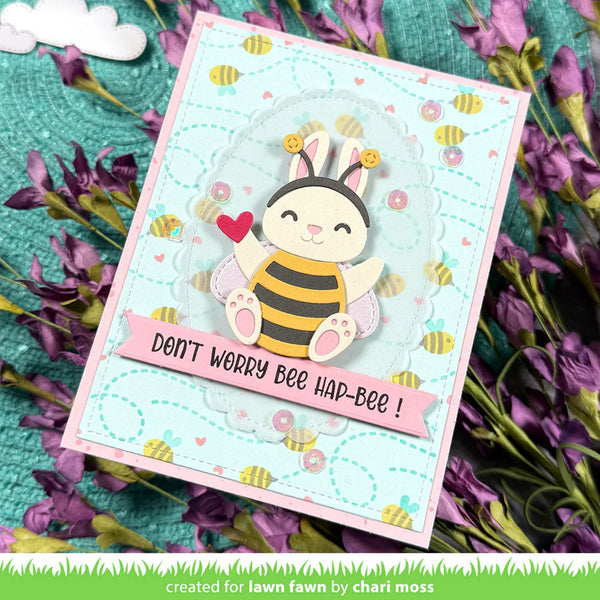 Card with a bee character holding a heart, surrounded by flowers, with text 'Don't worry bee hap-bee!'.
