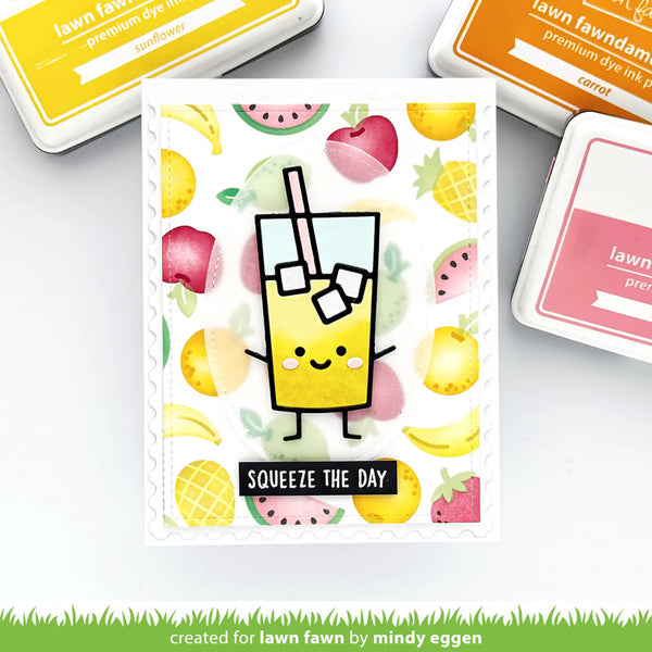 Card with a cartoon juice box and fruit design, surrounded by ink pads, on a white background.