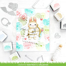 Card with a cute bunny holding a bow and arrow, surrounded by stamping tools on a white background.