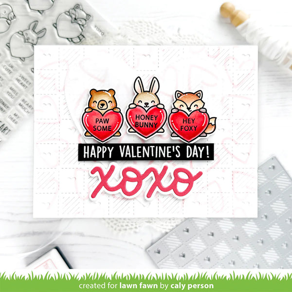 Valentine's Day card with cartoon animals holding hearts and 'Happy Valentine's Day! XOXO' text, surrounded by craft materials.