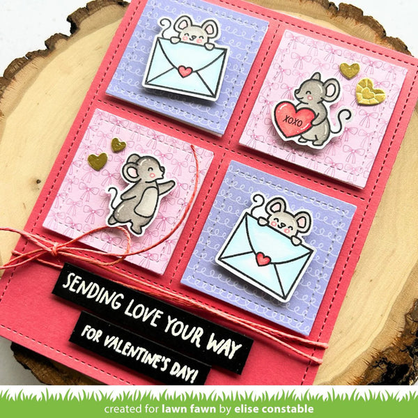 Valentine's Day card with mouse illustrations and text 'Sending love your way for Valentine's Day' on a wooden surface.