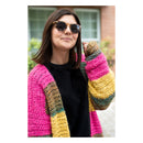Woman wearing a colorful striped cardigan with a blurred background