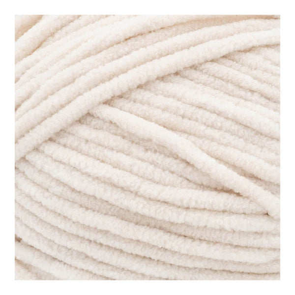 Close-up of beige yarn on a white background