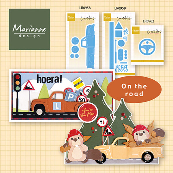 Collection of 'On the road' themed paper crafting elements with a bear and truck design, featuring Marianne Design branding.