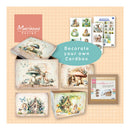Cardboard box with decorative elements and 'Marianne Design' branding on a patterned background.