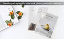 Greeting cards with floral design and text on a white surface