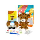 Crochet kit with materials and a partially completed Highland Cow toy on a white background