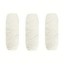 Three skeins of white yarn on a white background