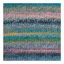 A close-up of a knitted fabric swatch showing horizontal stripes of blue, teal, green, pink, and yellow yarn in a textured knit pattern.