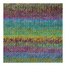A close-up of a knitted fabric texture with horizontal stripes in pastel rainbow colors including purple, blue, green, yellow, and pink.