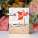 Card with colorful flower design and text, featuring Penny Black branding, against a floral background.