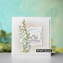 Card with decorative elements and text 'Find Joy in the Ordinary' by Penny Black on a blurred natural background.