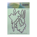 Penny Black Creative Dies with butterfly and flower shapes on a green cardstock background