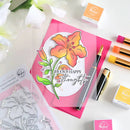 Card with floral design and text, surrounded by stamping tools on a white background