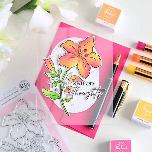 Card with floral design and text, surrounded by stamping tools on a white background