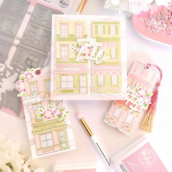 Decorative sticker sheets with building designs and floral elements on a light pink background.