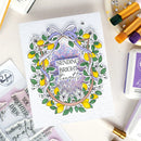 Card with floral design and text 'Sending Bright Thoughts' on a crafting surface with tools.
