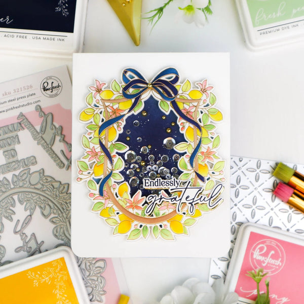 Colorful card with 'Endlessly grateful' text surrounded by decorative elements on a crafting table.