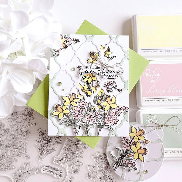 Card with floral design and 'Just a little sunshine for today' text, surrounded by craft supplies.