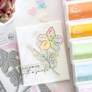 Floral card with 'Just for you with a smile' text, surrounded by stamping supplies on a light background.