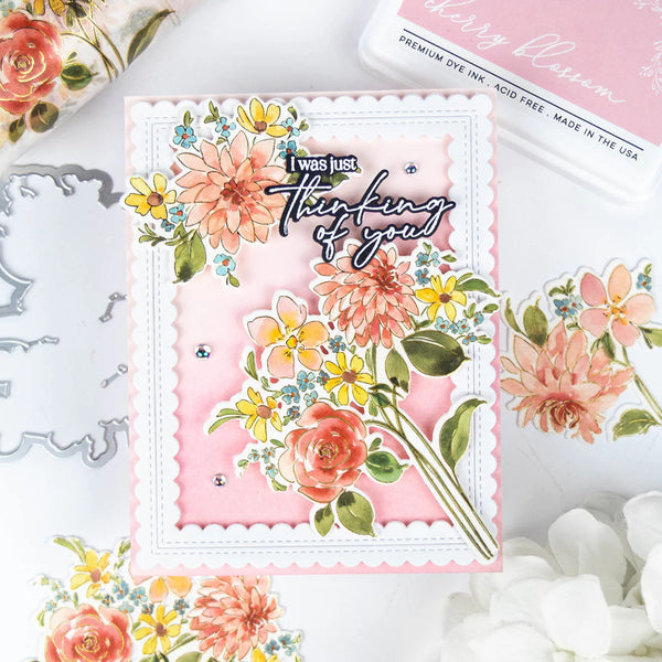 Floral card with 'I was just thinking of you' text, surrounded by floral elements and ink pads.