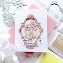 Card with floral design and 'Friends like you are everything' text, surrounded by crafting tools.