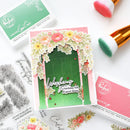 Handmade card with floral design and 'Wishing you a birthday full of good things' text, surrounded by stamping supplies.