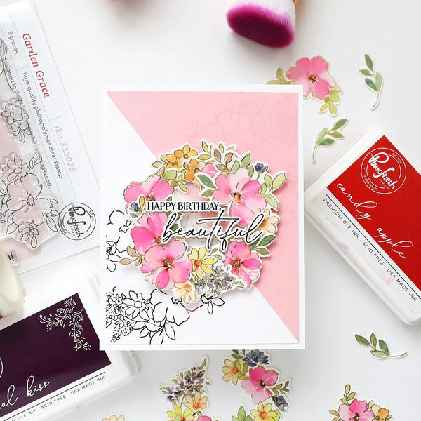 Floral card with 'Happy Birthday Beautiful' text on a pink background, surrounded by stamping tools.