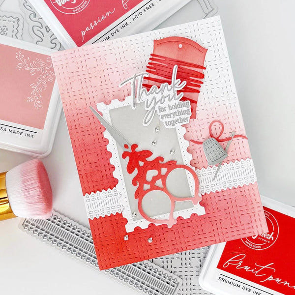 Card with red and white design featuring a reindeer and 'Thank you' text, surrounded by crafting tools on a light gray background.