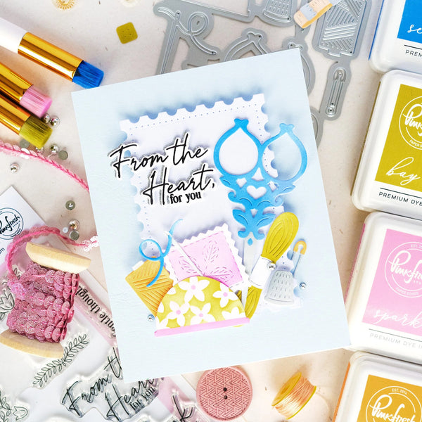 Card with 'From the Heart, for you' text surrounded by stamping supplies on a white background