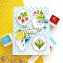 Card with floral and fruit designs on a yellow background