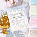 Card with 'missing our talks' text surrounded by stamp ink pads and tools on a light surface.
