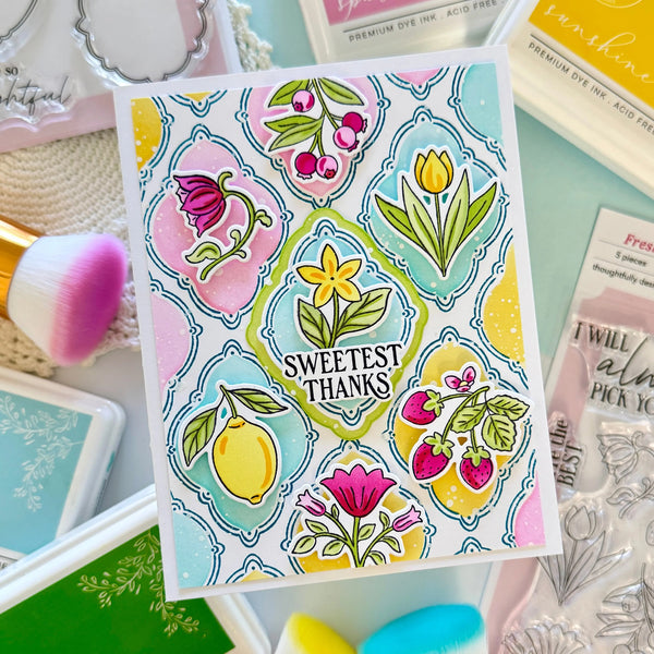 Colorful card with floral design and 'Sweetest Thanks' text, surrounded by crafting supplies.