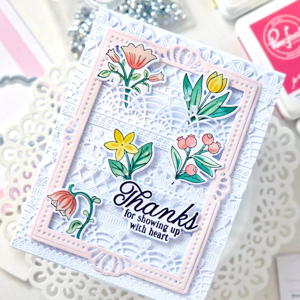 Card with floral design and 'Thanks for showing up with heart' text on a textured surface.